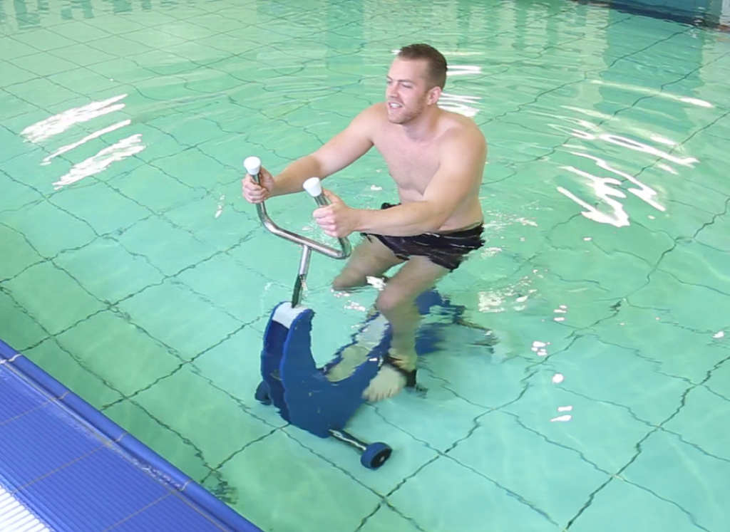 Underwater bicycle in hip deep water with model