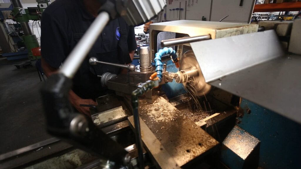 Turning a stainless steel component on the lathe in the EWAC Industrial workshop