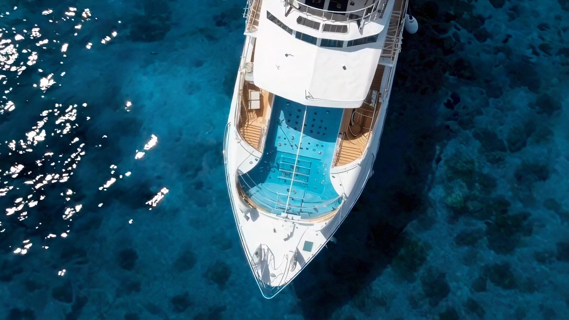 Aerial view of a superyacht with an on-deck pool
